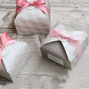 Detailed view of pink and grey gift boxes with satin ribbons and Thank You stickers