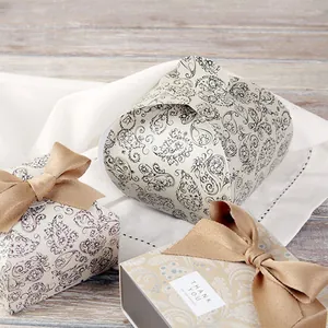 Detail of vintage blue paisley gift boxes with burlap bows and thank you labels