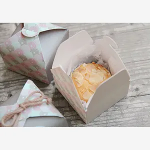 Detailed view of mini gift boxes with retro patterns for cupcakes and small soaps