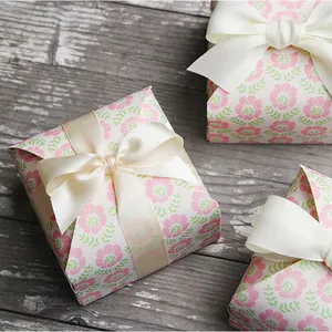 Detail of square floral gift box with pink flowers and creamy silk ribbon bow