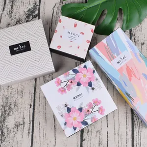 Detail of assorted gift boxes with geometric and floral designs on wood background