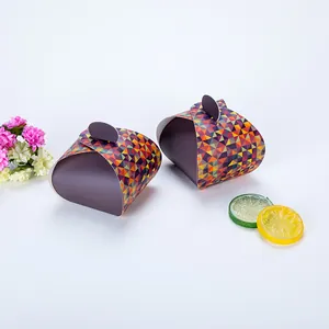 Detail of triangular cardboard gift boxes with geometric patterns and curved top closure