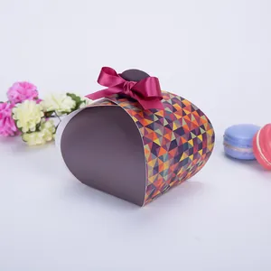 Exquisite curved gift box with geometric patterns and a dark red satin ribbon bow
