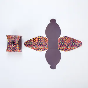 Macro view of folded and flat geometric gift box showing colorful triangle patterns