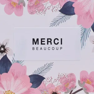 Square floral thank you sticker with Merci Beaucoup text and elegant pink flower pattern