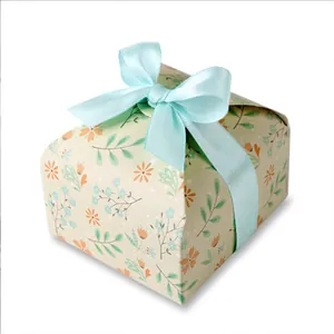 Detail of floral patterned gift box with a neat light blue satin ribbon bow