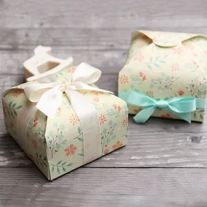 Detailed macro view of vintage floral gift boxes with silk ribbon bows on wood background