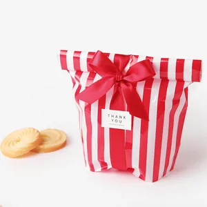 Detail of red striped food packaging bag with ribbon bow and thank you label