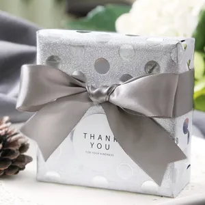 Silver gift box with mirror polka dots and elegant gray ribbon bow for premium packaging