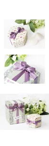 Detail view of floral hexagonal gift boxes with purple ribbon and thank you tags
