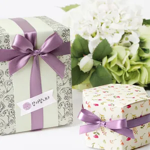 Light purple polyester satin ribbon on vintage paisley and floral gift boxes for weddings