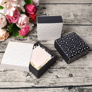 Square drawer gift box with geometric patterns for chocolates or soaps on wood surface