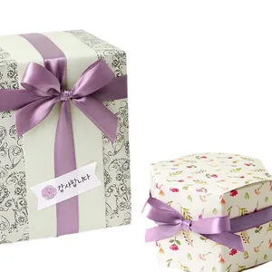 Light purple polyester ribbons on decorative gift boxes with floral and paisley patterns