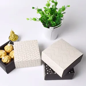 Modern square chocolate gift boxes with patterns and four-slot insert shown from above