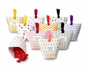 Colorful folding paper gift bags with various patterns and ribbons for candies