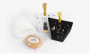 Détail de coffrets cadeaux de Noël avec rubans dorés et motifs d'ours et de cerf