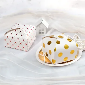 Square gold-stamped gift boxes with heart and polka dot patterns for weddings