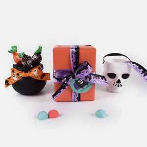 Halloween gift box with orange body, purple cartoon ribbon and a bat tag for treats