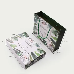 Detail view of tropical leaf gift box and matching paper bag with size dimensions