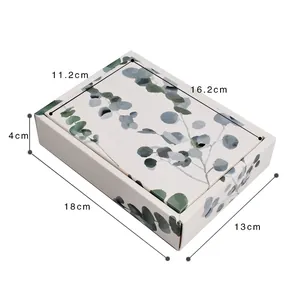 Detail showing dimensions of white folding paper box with eucalyptus leaf pattern