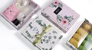 Detailed view of floral gift box set with 'Merci' print and elegant ribbon closure