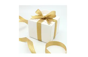 White gift box with gold glitter ribbon and wavy top design for wedding or party favors