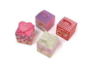 Detail view of assorted gift boxes featuring strawberry and bear prints with bow accents