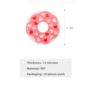 Close-up of pink donut-shaped gift bag with heart patterns and clear window