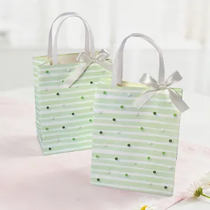 Elegant vintage light green gift bags with white stripes, polka dots and satin bow