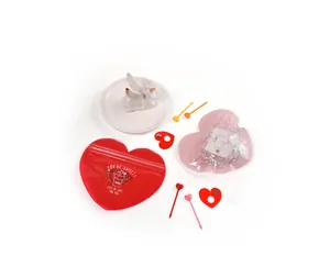 Detail of heart-shaped mini self-sealing gift bags for jewelry storage in pink and red