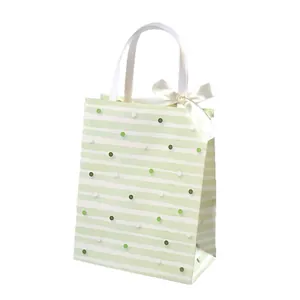 Elegant retro green striped gift bag with white ribbon bow and embossed paper texture