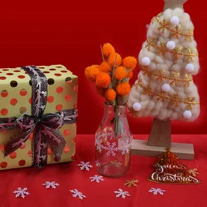 Golden and iridescent white snowflake ribbons for Christmas decorations and festive DIY crafts