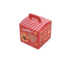 Detail of red bear cookie gift box with heart window and gingham pattern handle