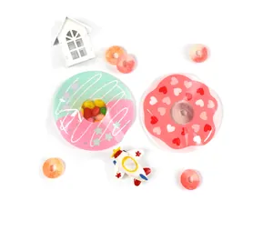 Flat lay of cute donut-shaped resin coasters with heart patterns and pastel colors