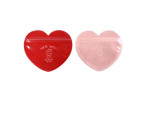 Macro shot of heart-shaped zip lock gift bags in red and pink with sweet text