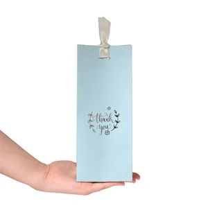 Light blue business gift bag with white silk bow and floral thank you print