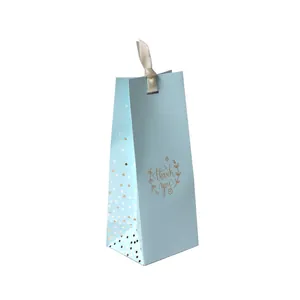 Elegant light blue gift bag with gold polka dots and ribbon handle for business ties