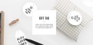 Minimalist white gift tags with handwritten text shown in a cozy Nordic lifestyle setting