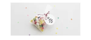 Detail of cone-shaped candy gift bag with a Smile On Your Face tag and colorful jelly beans