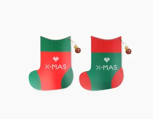Detail of Christmas stocking shaped gift boxes with X-MAS heart print and gold ornaments