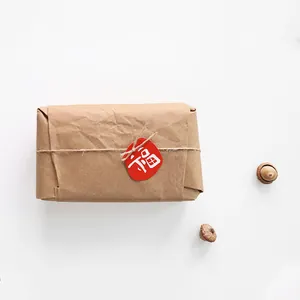 Brown kraft paper gift box with twine and red Fu character tag for Lunar New Year