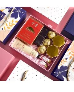 Detailed flat lay of a pink wedding gift box with cosmetics, sweets and luxury items