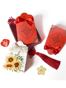 Detail of red wedding favor box with double happiness symbol, tassel and silk bow