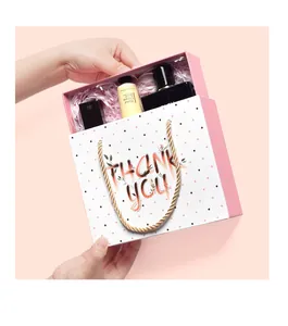 Detailed gift box view featuring perfume, hand cream and thank you card in pink packaging