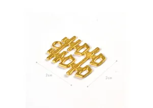 Macro detail of golden 2cm Double Happiness alloy charm with matte finish for DIY wedding decor