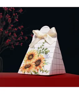 Detailed view of sunflower print gift box with cream silk ribbon on red display