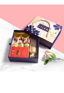 Detail of luxury wedding gift box featuring gold treats and floral patterns