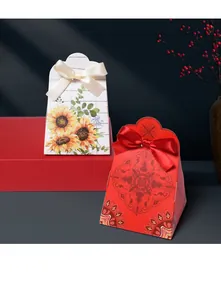 Detail of red wedding favor box with Chinese Xi symbol and white sunflower gift boxes