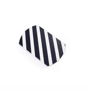 Detailed close-up of a high-quality black and white striped pillow-shaped gift box on white