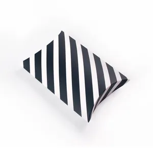 Macro detail of stripe pattern and folding structure on pillow-shaped cardboard gift box